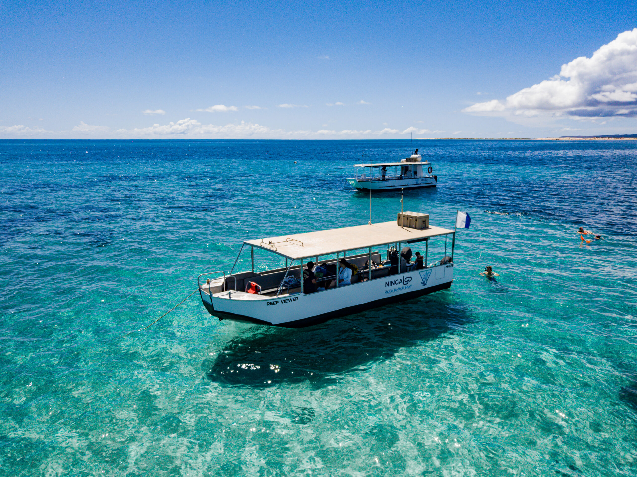 Reef Viewer and Ningaloo Coral Explorer II on the reef, boats used for glass bottom viewing and snorkelling in Exmouth
